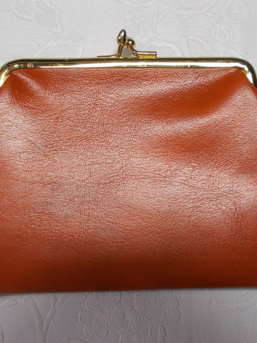 Vintage leather orange/rust color coin/wallet/pouch with gold-color snap